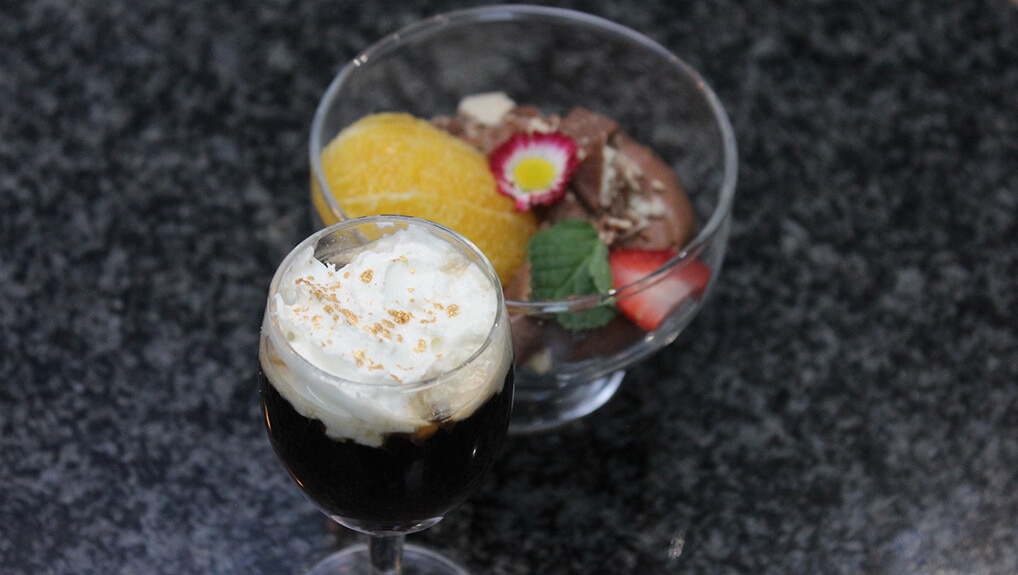 Chocolate vodka shot with chocolate mousse topped with cream & berries